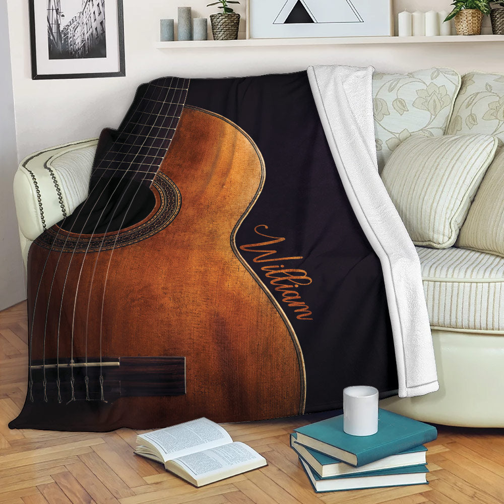 Acoustic guitar throw blanket draped over a sofa in a cozy living room setting