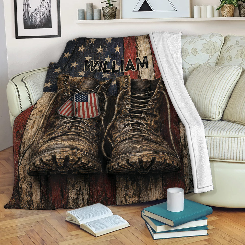 Patriotic veteran blanket displayed on a couch with combat boots, dog tags, and rustic flag design