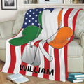 Close view of an Irish shamrock blanket draped over a couch with green, white, and orange artwork