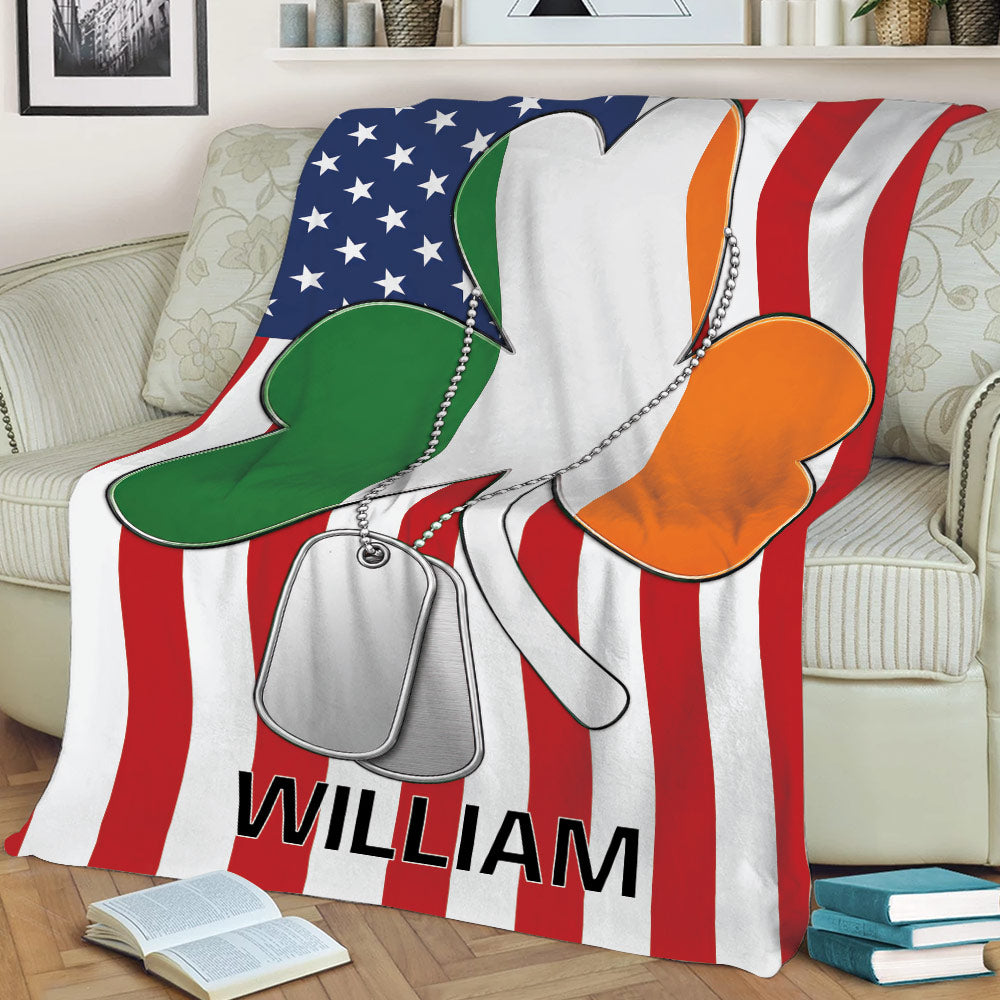 Close view of an Irish shamrock blanket draped over a couch with green, white, and orange artwork