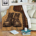 Veteran throw blanket draped over a sofa with military boots, dog tags, and rustic patriotic artwork