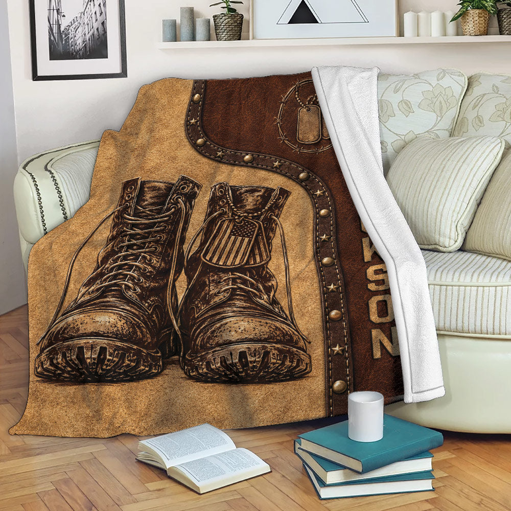 Veteran throw blanket draped over a sofa with military boots, dog tags, and rustic patriotic artwork