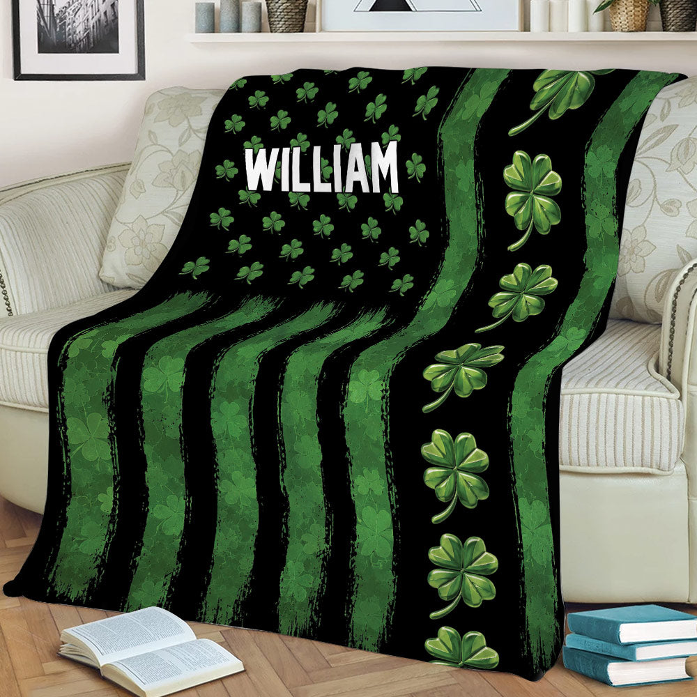 Irish throw blanket styled on a sofa with bold green stripes and repeating shamrock artwork