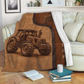 Rustic tractor blanket draped over a sofa with detailed farm vehicle artwork