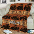 Tractor blanket styled across a couch with repeating agricultural vehicle illustrations and warm geometric bands