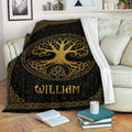 Black and gold Tree of Life throw blanket draped across a cozy sofa