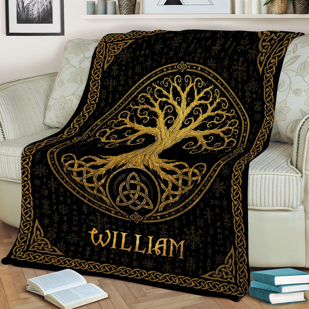 Tree of Life blanket displayed on a sofa with gold knotwork and black artwork
