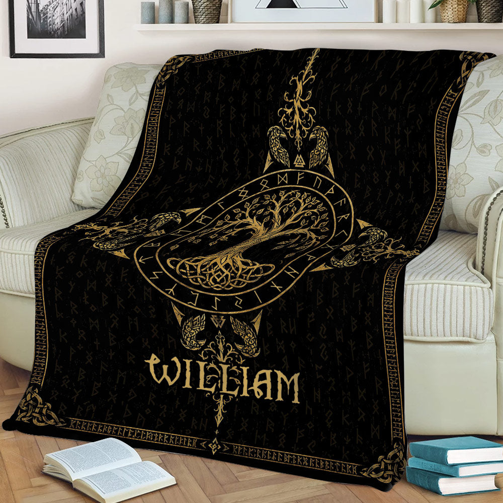 Ornate black and gold Tree Of Life blanket styled across a sofa with books