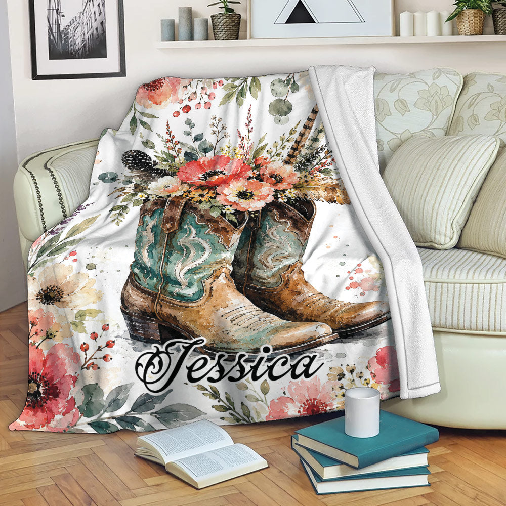 Cowboy throw blanket with Western boots and floral artwork draped over a living room sofa
