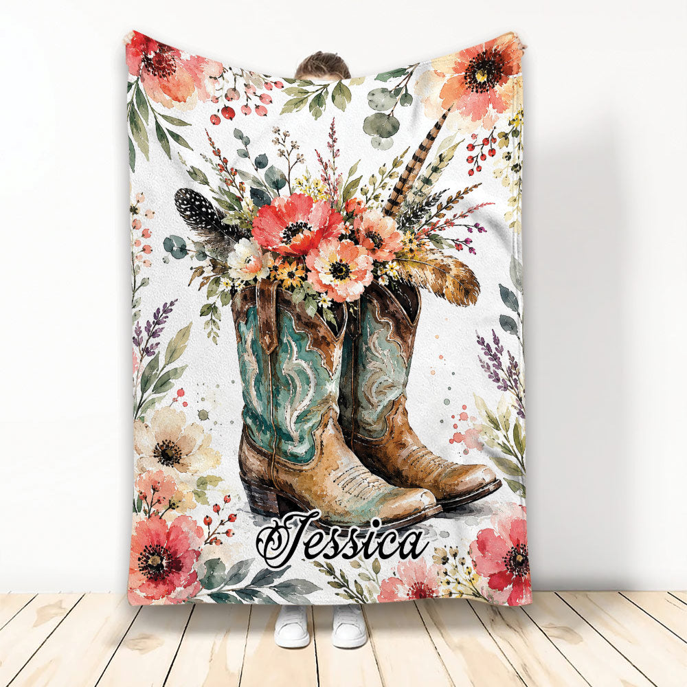 Cowboy blanket featuring Western boots, colorful wildflowers, feathers, and rustic floral artwork