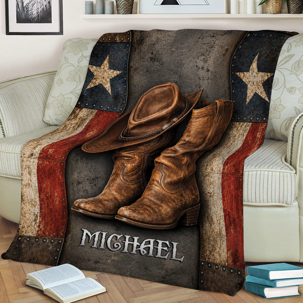 Western cowboy blanket styled on a sofa with leather hat, cowboy boots, star panels, and rustic colors