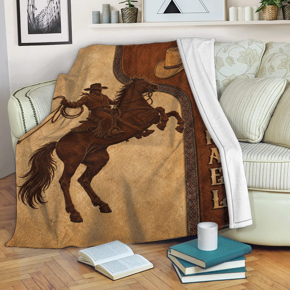 Rustic cowboy and horse throw blanket draped over a living room sofa