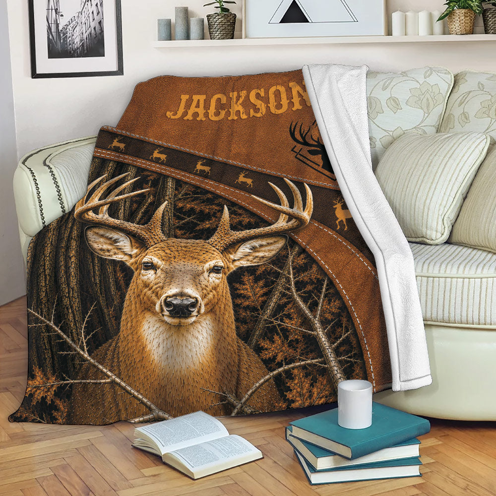 Deer hunting throw blanket draped over a sofa, showing woodland buck artwork in a cozy living room