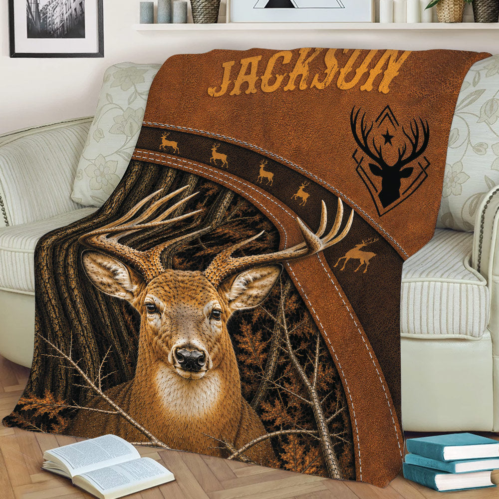 Rustic hunting blanket displayed on a sofa with a realistic buck, forest branches, and brown outdoor artwork