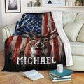 Patriotic deer hunting throw blanket displayed across a couch with bold red, white, and blue artwork