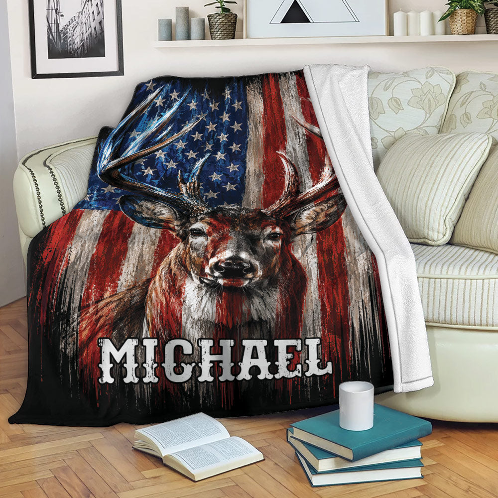 Patriotic deer hunting throw blanket displayed across a couch with bold red, white, and blue artwork