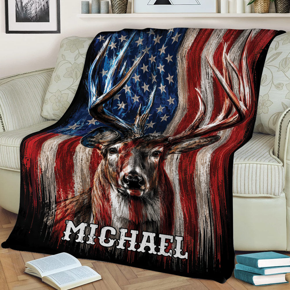 Close view of a buck hunting blanket draped over a sofa with rustic American flag artwork