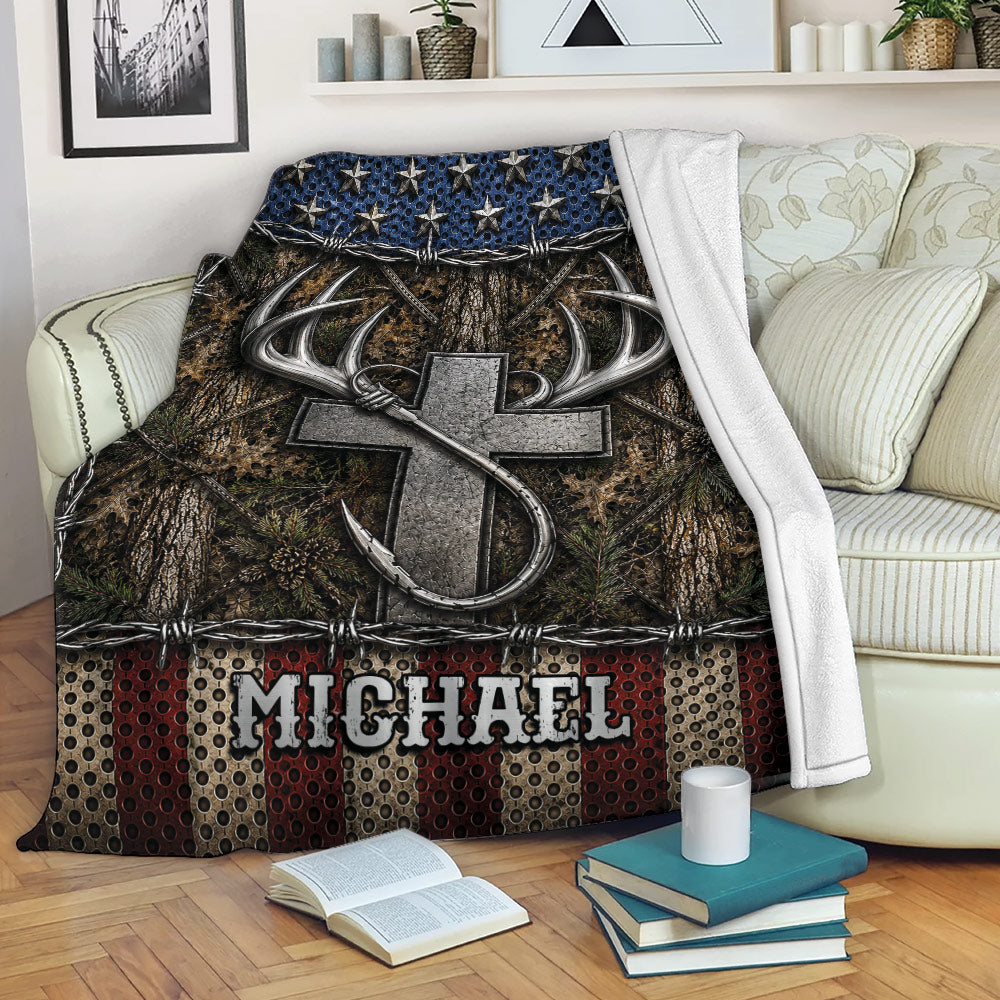 Fishing throw blanket displayed on a sofa with a large hook, antlers, woodland camouflage, and rustic colors