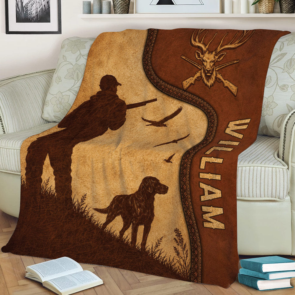 Close lifestyle view of a rustic hunting throw blanket with hunter, dog, birds, deer emblem, and leather-style details