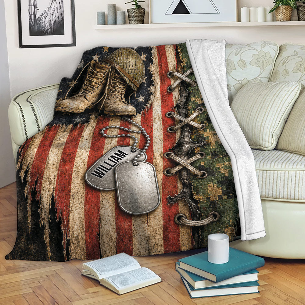 Veteran throw blanket displayed on a sofa with combat boots, dog tags, camouflage, and patriotic military artwork