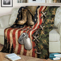 Military tribute throw blanket draped over a sofa with combat boots, helmet, dog tags, and American flag design