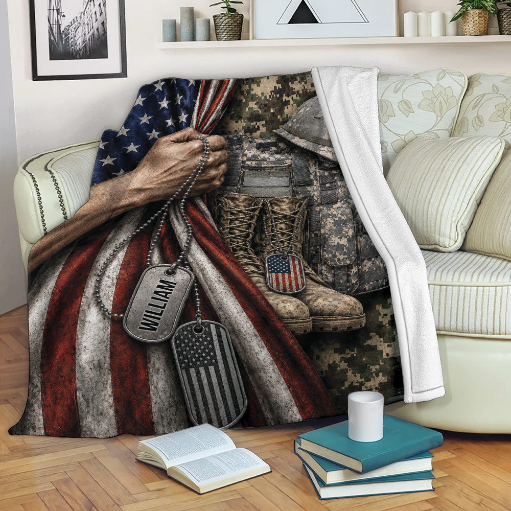 Patriotic veteran blanket draped over a sofa with military uniform, boots, helmet, and dog tags