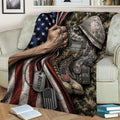 Close lifestyle view of a veteran throw blanket featuring camouflage gear, combat boots, dog tags, and flag