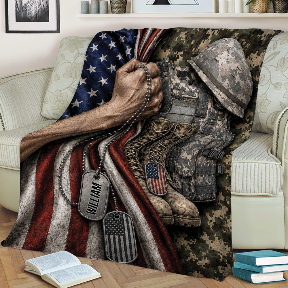 Close lifestyle view of a veteran throw blanket featuring camouflage gear, combat boots, dog tags, and flag