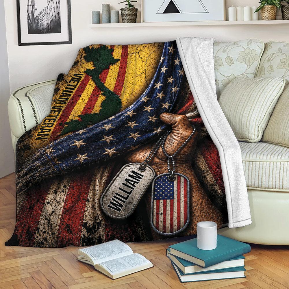 Patriotic veteran blanket draped over a sofa with American flag artwork and military-inspired dog tags