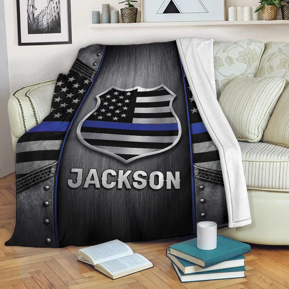 Police throw blanket displayed on a sofa with shield emblem and thin blue line artwork