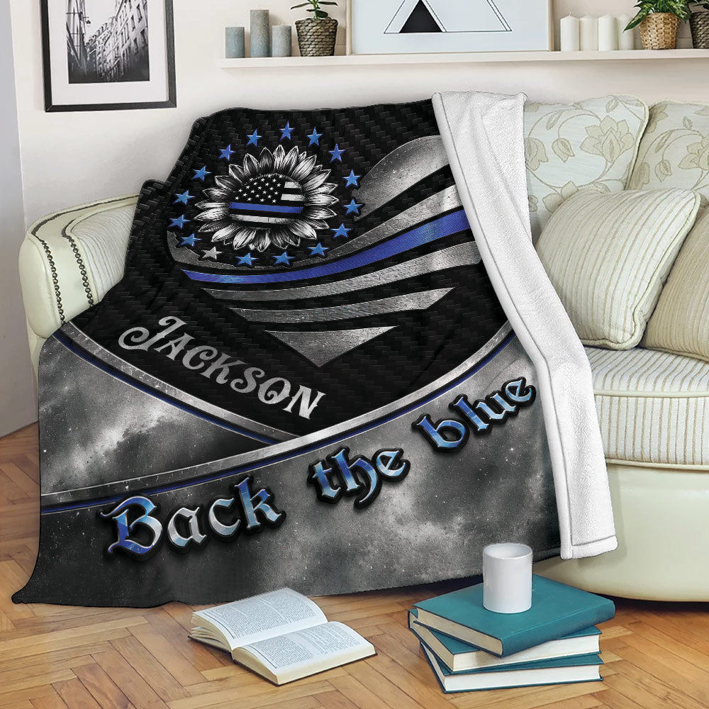 Police throw blanket displayed on a sofa with patriotic sunflower artwork and thin blue line symbolism