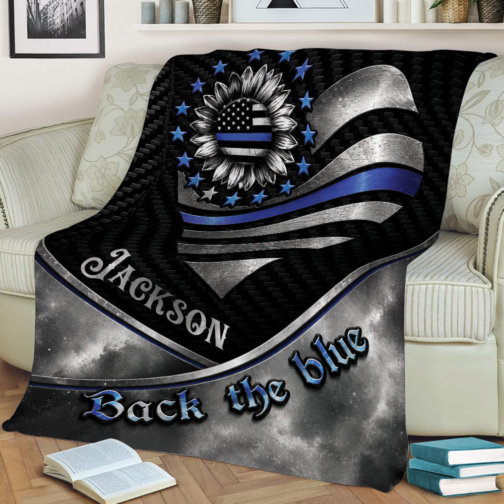 Law enforcement throw blanket styled on a couch with a patriotic sunflower and bold blue and silver design