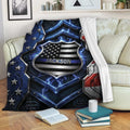 Police-themed throw blanket draped over a couch with patriotic shield artwork and blue line design