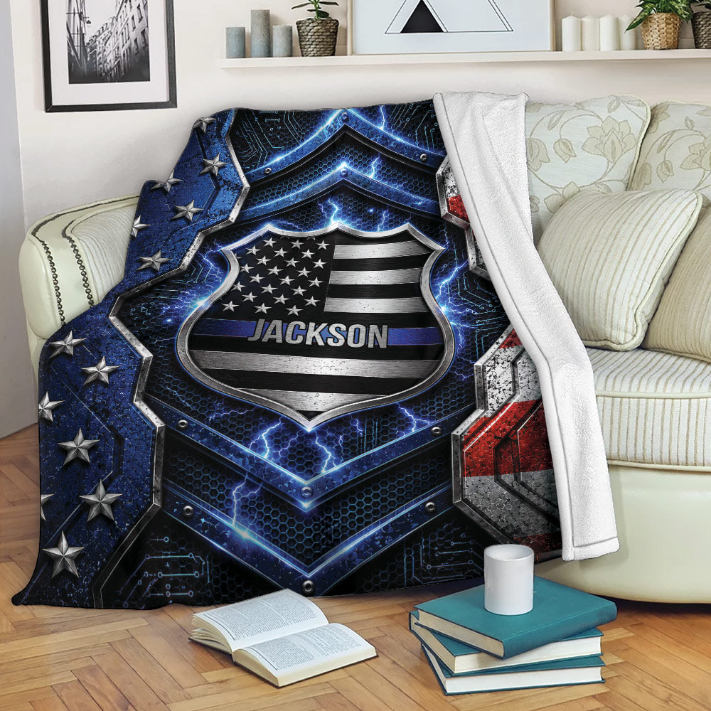 Police-themed throw blanket draped over a couch with patriotic shield artwork and blue line design