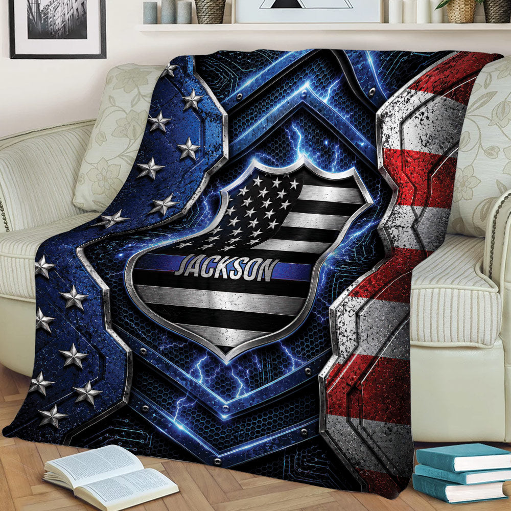 Patriotic police throw blanket displayed on a sofa with shield artwork, stars, and blue line details