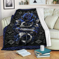 Police blanket draped over a sofa with blue rose and handcuff artwork in a cozy living room