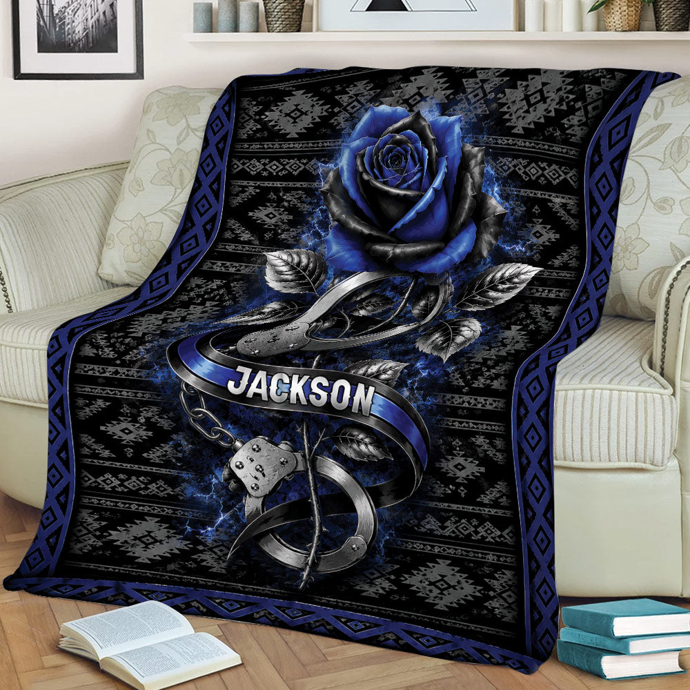 Black and blue police throw blanket displayed on a sofa with blue rose and handcuff design