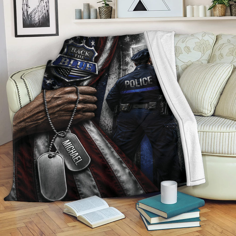 Police throw blanket displayed on a sofa with law enforcement artwork and patriotic red, white, and blue details