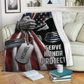 Police blanket displayed on a sofa with patriotic law enforcement artwork