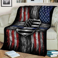Thin blue line police blanket draped over a couch with patriotic badge and flag artwork
