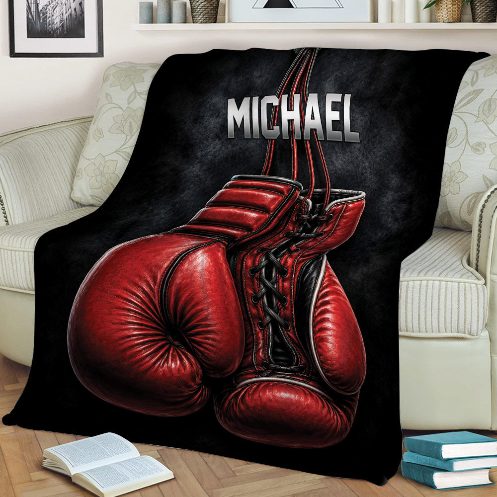 Boxing blanket styled on a sofa featuring large red gloves and dark athletic artwork