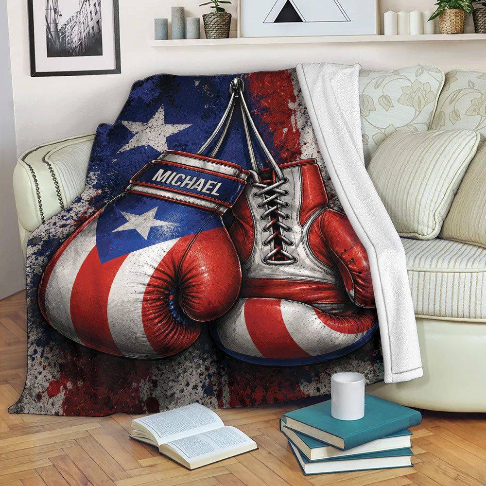 Boxing blanket draped over a couch, showcasing red and blue gloves with distressed patriotic artwork