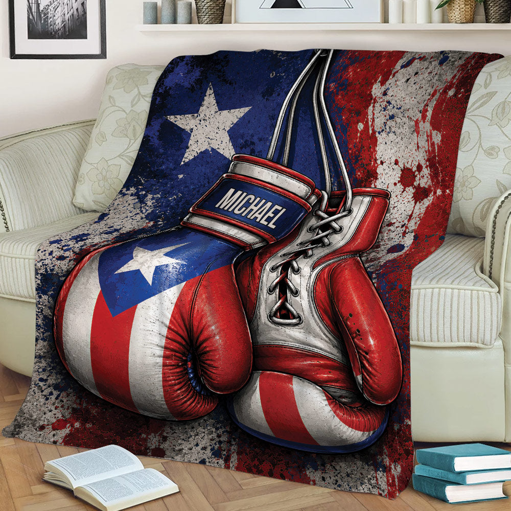 Close lifestyle view of a boxing throw blanket with oversized gloves and bold red, white, and blue graphics