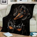 Dachshund throw blanket draped across a sofa with expressive black and tan dog artwork