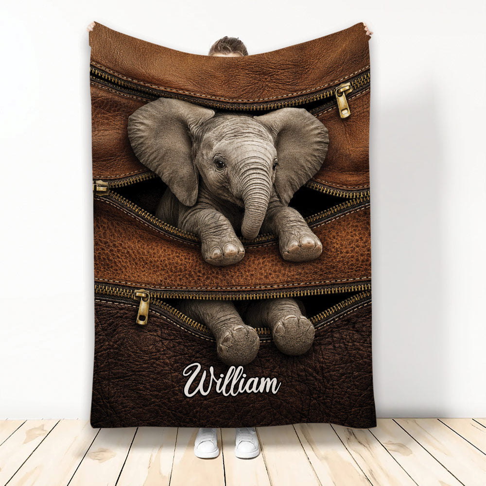 Elephant throw blanket featuring a lifelike baby elephant emerging from a brown zippered leather-style design