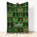 Irish throw blanket with green tartan patchwork, shamrocks, and colorful ribbon accents