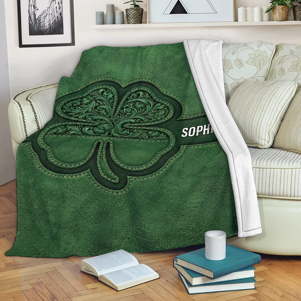 Irish shamrock throw blanket with ornate green artwork draped over a living room sofa