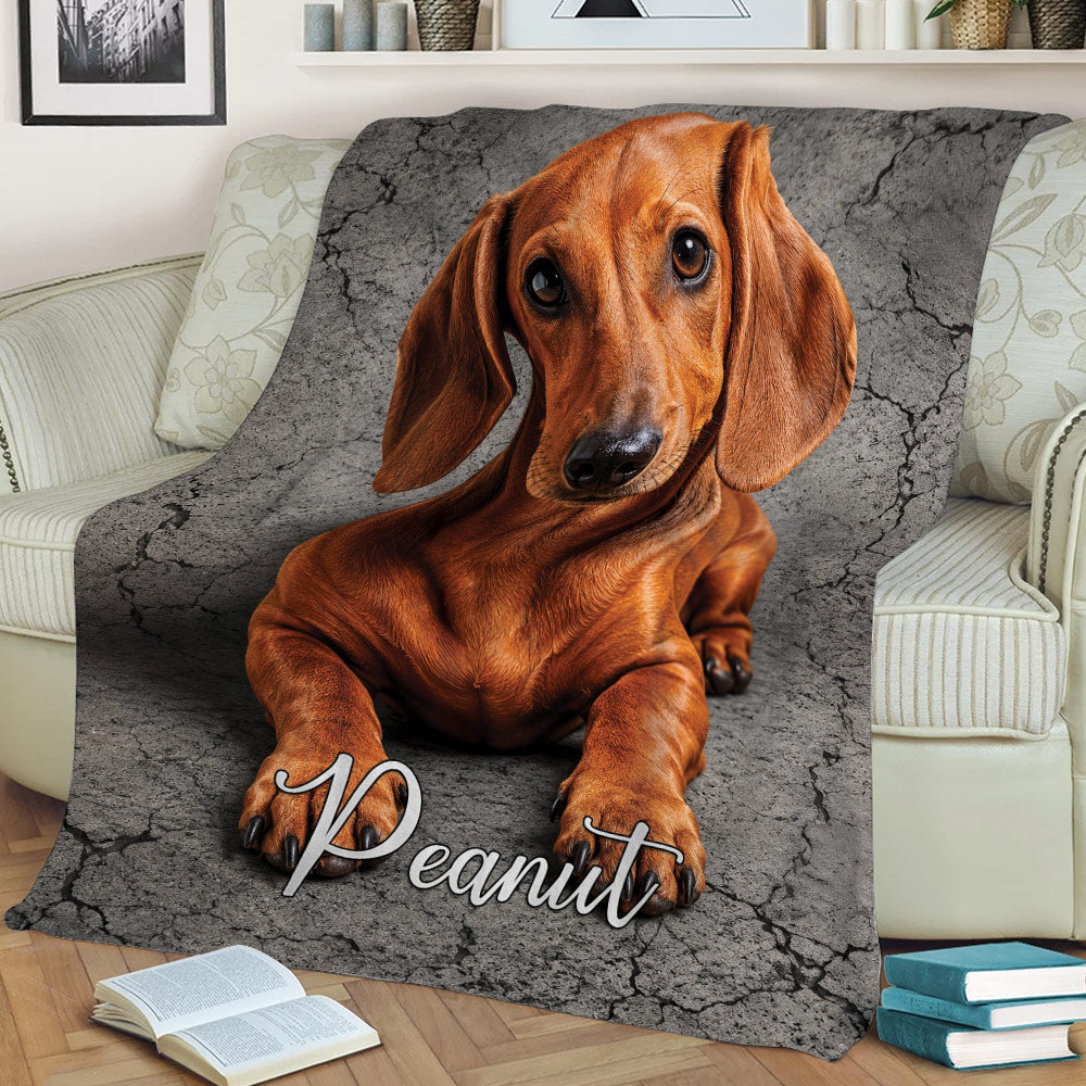 Brown dachshund throw blanket displayed on a sofa in a cozy living room setting