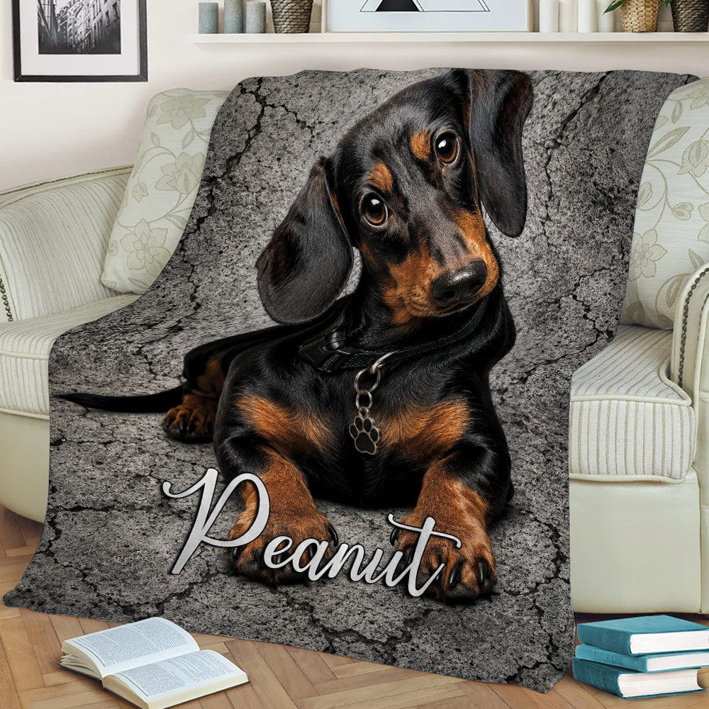 Dachshund throw blanket draped over a chair with detailed black and tan dog artwork