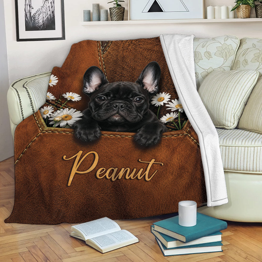 French Bulldog blanket displayed on a sofa with floral artwork and cozy living room decor